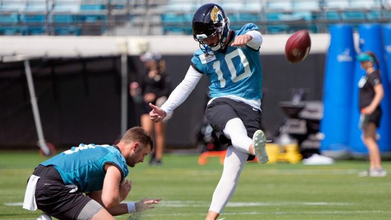 Jacksonville Jaguars kicker Brandon McManus (10) works on field goals as Logan Cooke holds during an NFL football practice, Tuesday, May 30, 2023, in Jacksonville, Fla. (John Raoux/AP)