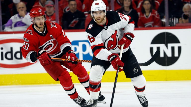 New Jersey Devils' Damon Severson (28) controls the puck in front of Carolina Hurricanes' Sebastian Aho (20) during the first period of Game 2 of an NHL hockey Stanley Cup second-round playoff series in Raleigh, N.C., Friday, May 5, 2023. (Karl B DeBlaker/AP)