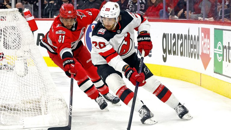 New Jersey Devils' Michael McLeod (20) controls the puck in front of Carolina Hurricanes' Shayne Gostisbehere (41) during the first period of Game 1 of an NHL hockey Stanley Cup second-round playoff series in Raleigh, N.C., Wednesday, May 3, 2023. (Karl B DeBlaker/AP)