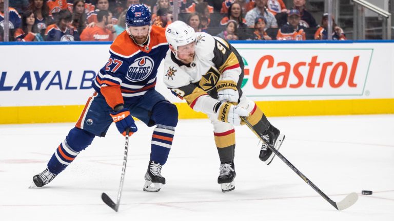 Vegas Golden Knights' Jack Eichel (9) and Edmonton Oilers' Brett Kulak (27) battle for the puck during first period NHL Stanley Cup second round playoff action in Edmonton on Sunday May 14, 2023. (Jason Franson/CP)