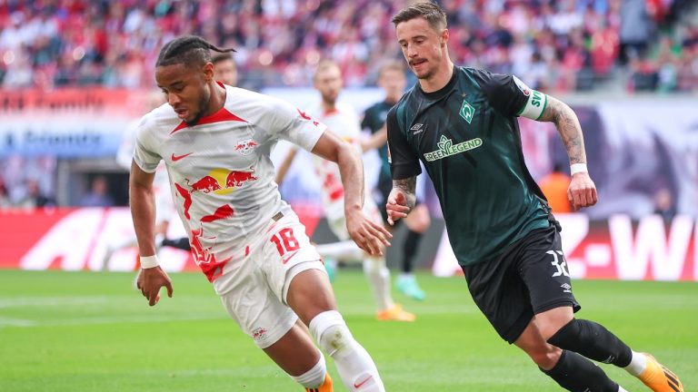 Leipzig's Christopher Nkunku, left, and Bremen's Marco Friedl, right, challenge for the ball during the German Bundesliga soccer match between RB Leipzig and SV Werder Bremen. (Jan Woitas/dpa via AP)