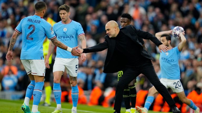 Manchester City's head coach Pep Guardiola shakes hands with Manchester City's Kyle Walker during the Champions League semifinal second leg soccer match between Manchester City and Real Madrid at Etihad stadium in Manchester, England, Wednesday, May 17, 2023. (Jon Super/AP)