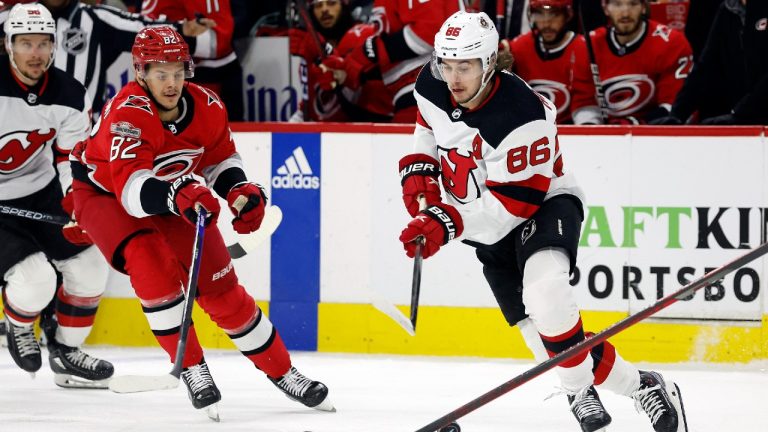 New Jersey Devils' Jack Hughes (86) controls the puck in front of Carolina Hurricanes' Jesperi Kotkaniemi (82) during the first period in Game 5 of an NHL hockey Stanley Cup second-round playoff series in Raleigh, N.C., Thursday, May 11, 2023. (Karl B DeBlaker/AP)
