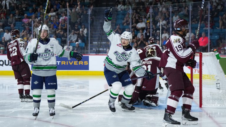 Seattle Thunderbirds' Lucas Ciona, centre, and Kyle Crnkovic, left, celebrate Ciona's goal against Peterborough Petes goalie Michael Simpson (31) as Donovan McCoy (19) skates past during second period Memorial Cup hockey action, in Kamloops, B.C., on Saturday, May 27, 2023. (Darryl Dyck/CP)