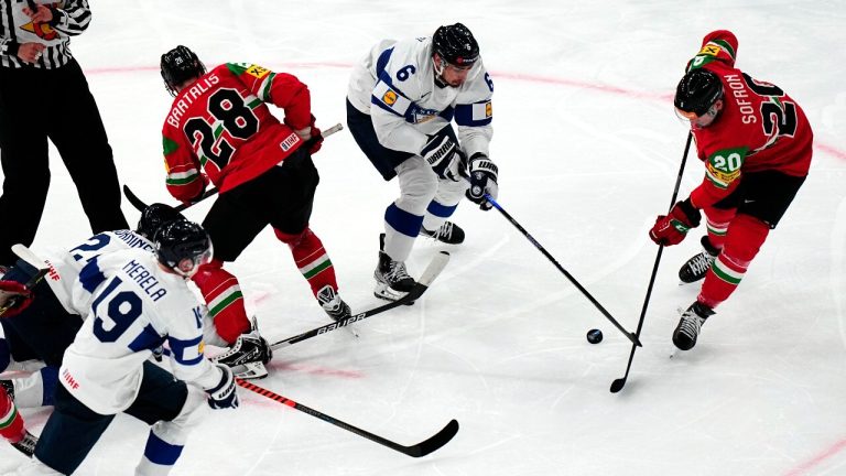 Hungary's Istvan Sofron, right, and Finland's Niklas Friman battle for the puck during the group A match between Hungary and Finland at the ice hockey world championship in Tampere, Finland, Friday, May 19, 2023. (Pavel Golovkin/AP)