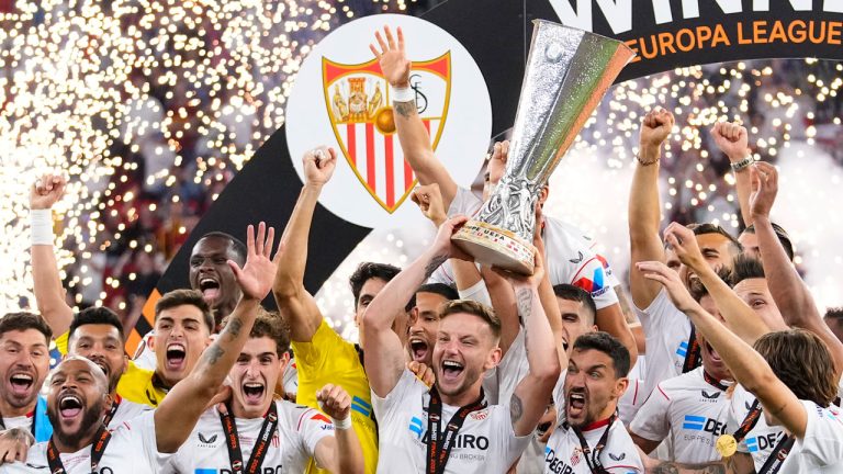 Sevilla's team captain Ivan Rakitic lifts the trophy after winning the Europa League final soccer match between Sevilla and Roma, at the Puskas Arena in Budapest, Hungary, Wednesday, May 31, 2023. Sevilla defeated Roma 4-1 in a penalty shootout. (Petr David Josek/AP)