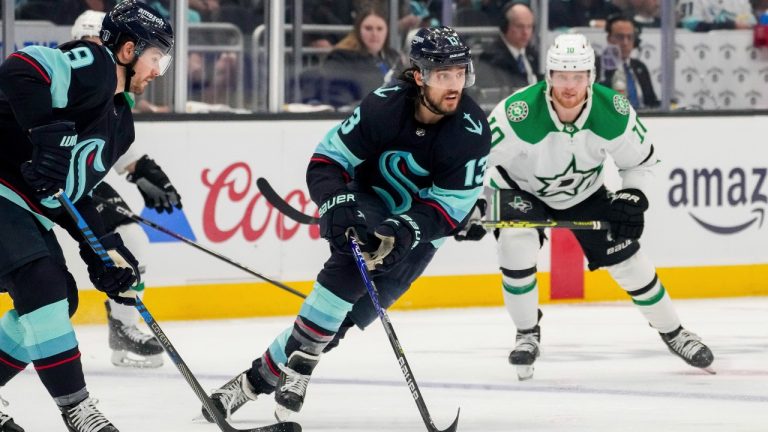 Seattle Kraken left wing Brandon Tanev (13) moves the puck as Dallas Stars center Ty Dellandrea (10) watches during the second period of Game 6 of an NHL hockey Stanley Cup second-round playoff series Saturday, May 13, 2023, in Seattle. (Lindsey Wasson/AP Photo)
