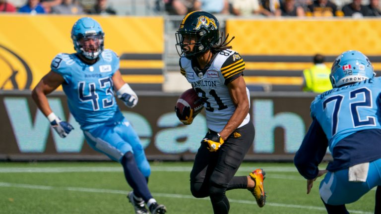 Hamilton Tiger Cats wide receiver Lio'undre Gallimore (81) runs on his way to a long return for a touchdown against the Toronto Argonauts during first half CFL pre-season football action in Hamilton on Saturday, May 27, 2023. (Peter Power/CP)