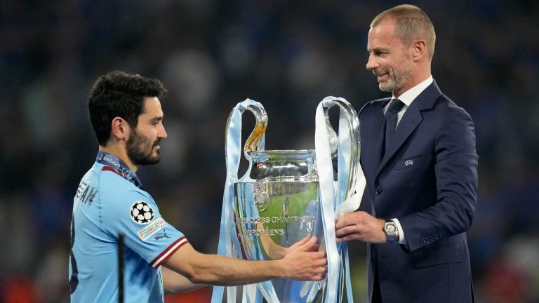 UEFA president Aleksander Ceferin hands the trophy to Manchester City's team captain Ilkay Gundogan after they won the Champions League final soccer match between Manchester City and Inter Milan at the Ataturk Olympic Stadium in Istanbul, Turkey, Sunday, June 11, 2023. Manchester City won 1-0. (Francisco Seco/AP)