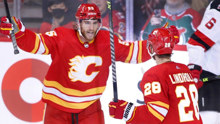 Calgary Flames' Elias Lindholm, right, celebrates his goal against the New Jersey Devils with Noah Hanifin during second period NHL hockey action in Calgary, Saturday, Nov. 5, 2022. (Larry MacDougal/CP)