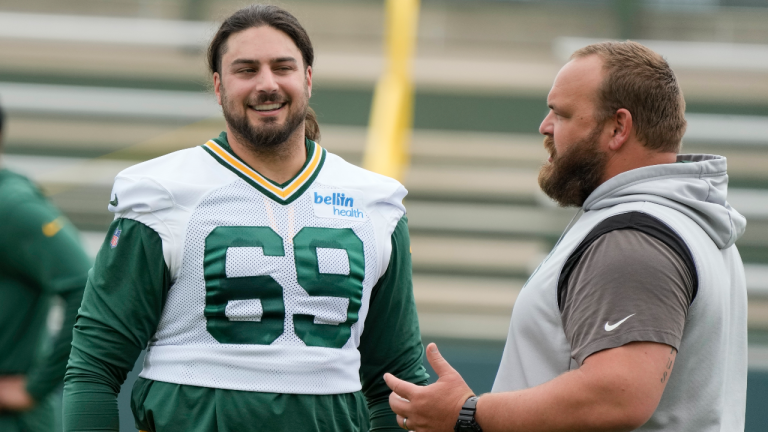 Green Bay Packers' David Bakhtiari talks to coach Luke Butkus during an NFL football OTA practice session Wednesday, May 31, 2023, in Green Bay, Wis. (AP Photo/Morry Gash)