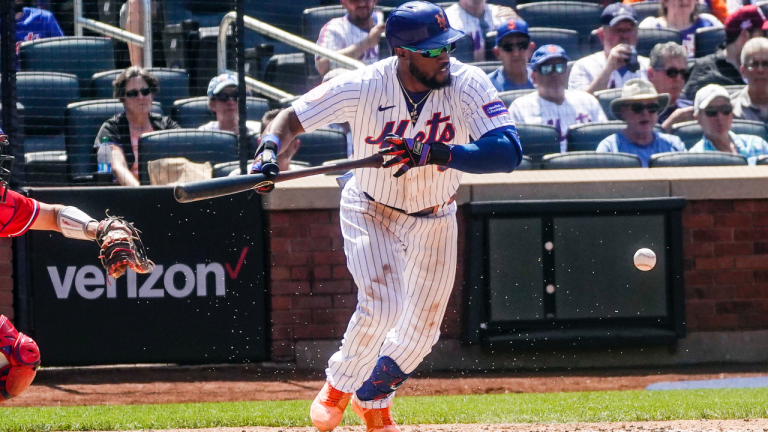 New York Mets batter Starling Marte drops a sacrifice bunt to advance a player to third in the sixth inning of a baseball game against Philadelphia Phillies, Thursday, June 1, 2023, in New York. (AP Photo/Bebeto Matthews)