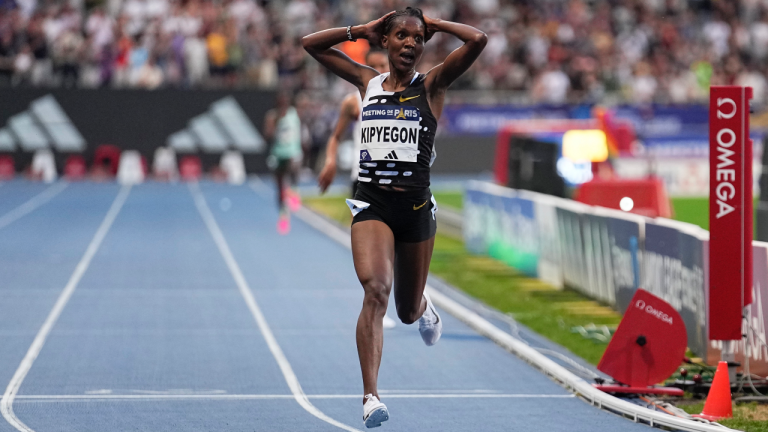 Faith Kipyegon, of Kenya, crosses the finish line to win the Women 5000 metres setting a new world record during the Meeting de Paris Diamond League athletics meet in Paris, Friday, June 9, 2023. (AP Photo/Michel Euler)