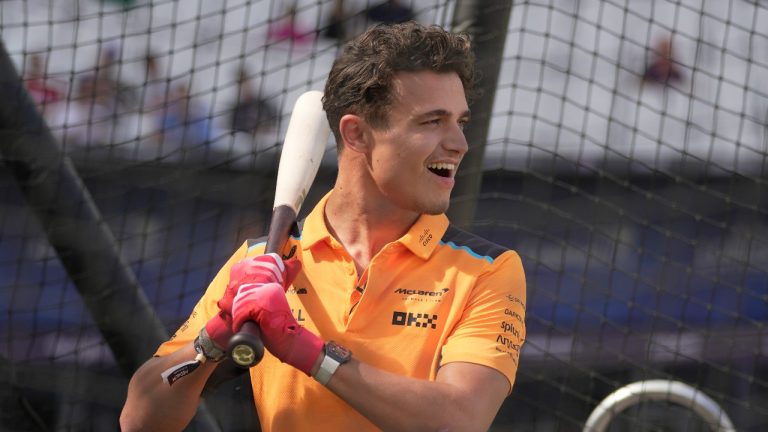 Lando Norris Formula One driver for Mclaren smiles during St. Louis Cardinals' training session ahead of the baseball match against Chicago Cubs at the MLB World Tour London Series, in London Stadium. (Kin Cheung/AP)