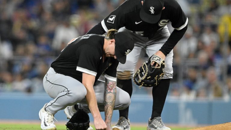 Chicago White Sox first baseman Andrew Vaughn, right, checks on injured starting pitcher Mike Clevinger after a pitch to Los Angeles Dodgers designated hitter J.D. Martinez during the fifth inning of a baseball game in Los Angeles, Wednesday, June 14, 2023. Clevinger was taken out of the game after an evaluation at the mound. (Alex Gallardo/AP)