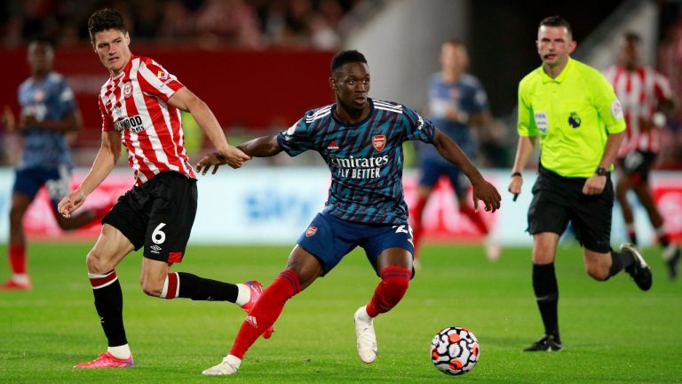 Brentford's Christian Norgaard vies for the ball with Arsenal's Folarin Balogun, center, during the English Premier League soccer match between Brentford and Arsenal at the Brentford Community Stadium in London, England, Friday, Aug. 13, 2021. (Ian Walton/AP)