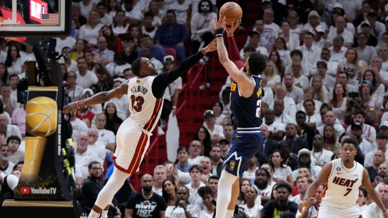Denver Nuggets guard Jamal Murray (27) aims a three-point shot as Miami Heat centre Bam Adebayo (13) defends during the second half of Game 4 of the basketball NBA Finals, Friday, June 9, 2023, in Miami. (Wilfredo Lee/AP)