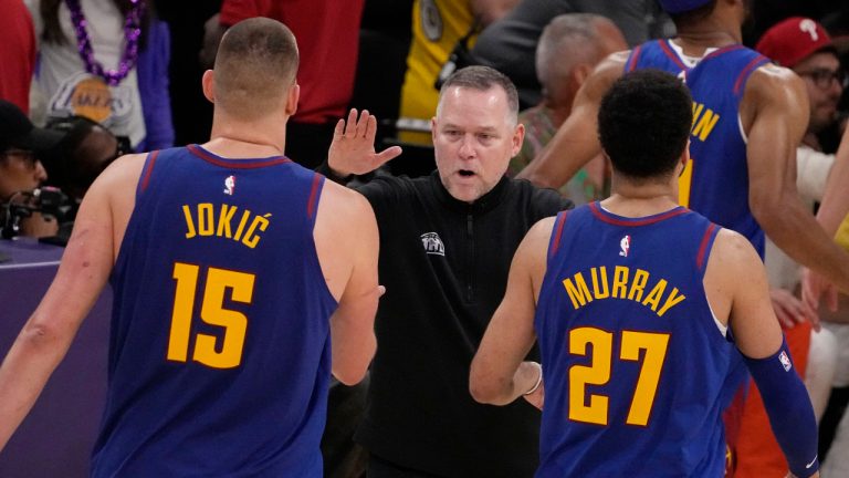 Denver Nuggets head coach Michael Malone, center, shakes hands with Denver Nuggets center Nikola Jokic (15) and guard Jamal Murray (27) in the second half of Game 3 of the NBA basketball Western Conference Final series against the Los Angeles Lakers Saturday, May 20, 2023, in Los Angeles. (Mark J. Terrill/AP)