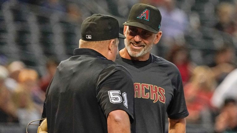 Arizona Diamondbacks manager Torey Lovullo chats with umpire Marvin Hudson during the Colorado Rockies baseball game Thursday, June 1, 2023, in Phoenix. (Darryl Webb/AP)
