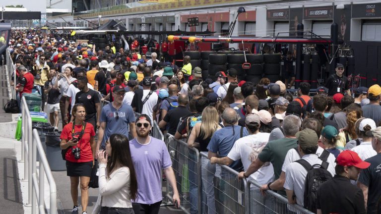 Race fans walk through pit lane during the open house at the Canadian Grand Prix. (Ryan Remiorz/THE CANADIAN PRESS)
