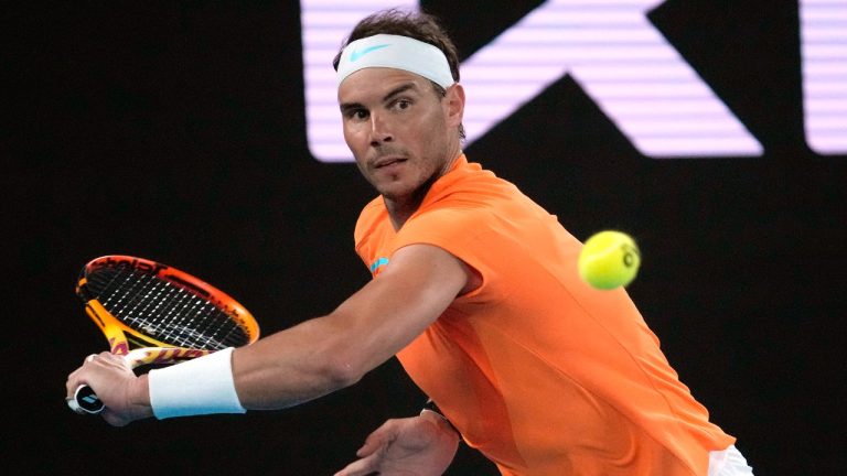 Rafael Nadal of Spain plays a backhand return to Mackenzie McDonald of the U.S. during their second round match at the Australian Open tennis championship in Melbourne, Australia, Wednesday, Jan. 18, 2023. (Dita Alangkara/AP)
