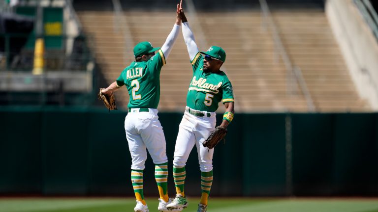 Oakland Athletics' Nick Allen (2) celebrates with Tony Kemp (5) after the Athletics defeated the Boston Red Sox in a baseball game in Oakland, Calif., Wednesday, July 19, 2023. (Jeff Chiu/AP)