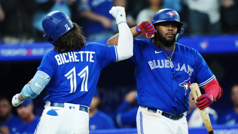 Toronto Blue Jays shortstop Bo Bichette celebrates his solo home run against the Detroit Tigers with teammate Vladimir Guerrero Jr. (27) during eighth inning MLB American League baseball action in Toronto on Tuesday, April 11, 2023. (Nathan Denette/CP)
