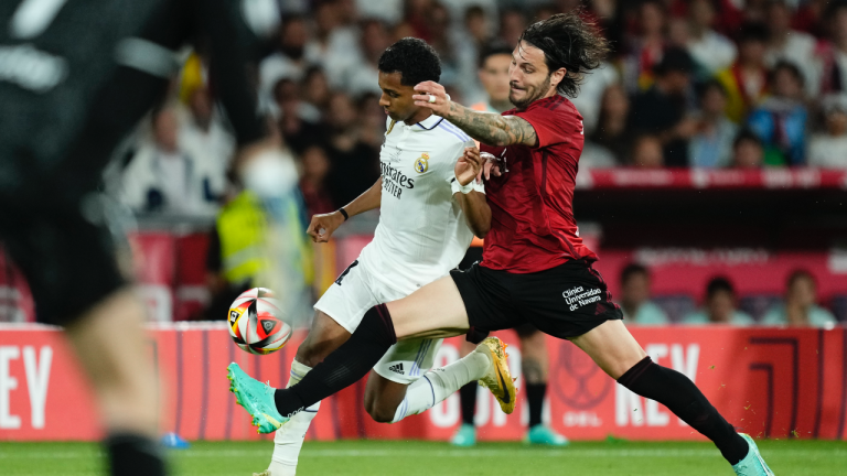 Real Madrid's Rodrygo, left, and Osasuna's Juan Cruz challenge for the ball during the Copa del Rey soccer final between Real Madrid and Osasuna at La Cartuja stadium in Seville, Spain, Saturday, May 6, 2023. (AP Photo/Jose Breton)