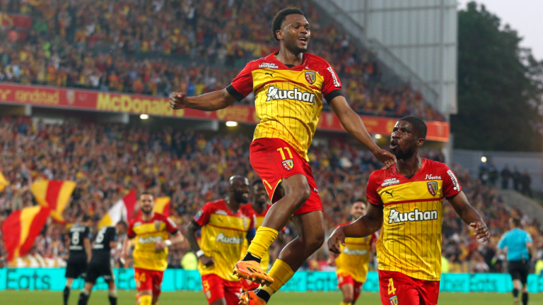 Lens' Lois Openda, center, celebrates after scoring during a French League One soccer match between Lens and Ajaccio at the Bollaert stadium in Lens, France, Saturday, May 27, 2023. (AP)