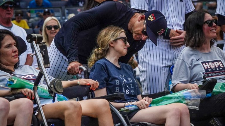 New York Yankees manager Aaron Boone, center, talk with Sarah Langs, their HOPE Week honoree, on the 84th anniversary of Lou Gehrig making his famous "Luckiest Man" speech, Tuesday, July 4, 2023, in New York. Langs, one of Major League Baseball's most respected and universally liked statistical analysts, has been in a battle with ALS the last three years. Langs and women from the organization "Her ALS Story" made a pregame tour of Monument Park and the Yankees Museum. (Bebeto Matthews/AP)