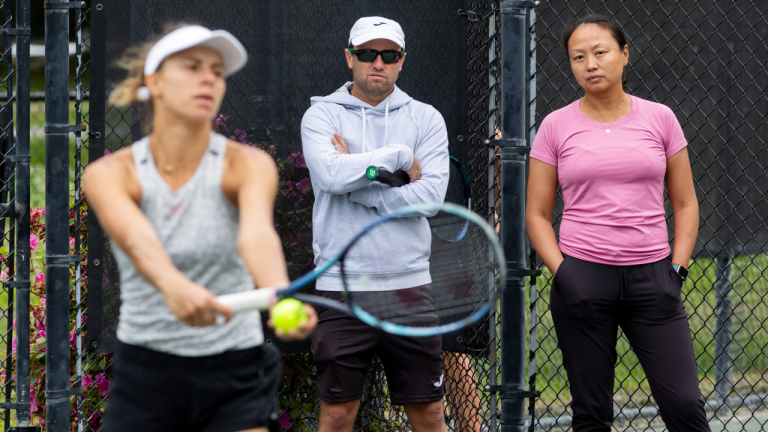 Lan Yao-Gallop and coach Mark Gellard, center, watch as Magda Linette prepares to serve on a practice court at the Charleston Open tennis tournament in Charleston, S.C., Monday, April 3, 2023. Yao-Gallop is a member of the women’s professional tennis tour’s Coach Inclusion Program to develop female coaches. (AP)