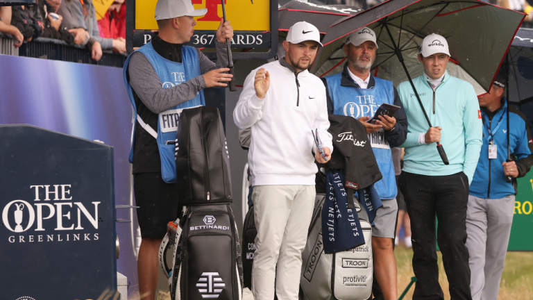 England's Matt Fitzpatrick, right with his brother Alex Fitzpatrick wait under umbrellas to play on the 4th tee box during a practice round for the British Open Golf Championships at the Royal Liverpool Golf Club in Hoylake, England, Monday, July 17, 2023. The Open starts Thursday, July 20. (AP)