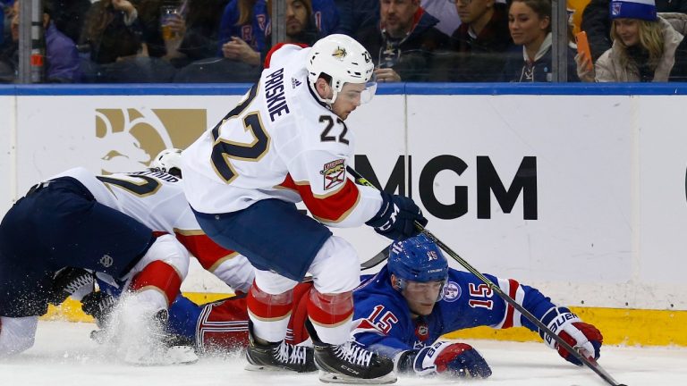 New York Rangers' Julien Gauthier (15) continues to compete with Florida Panthers' Chase Priskie (22) for the puck after being tripped by Panthers' Brandon Montour (62) during the first period of an NHL hockey game Tuesday, Feb. 1, 2022, in New York. (John Munson/AP)