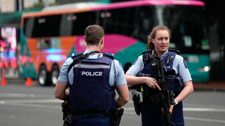 Armed New Zealand police officers stand outside a hotel housing a team from the FIFA Women's World Cup in the central business district following a shooting in Auckland, New Zealand, Thursday, July 20, 2023. New Zealand police are responding to reports that a gunman has fired shots in a building in downtown Auckland. (Abbie Parr/AP)