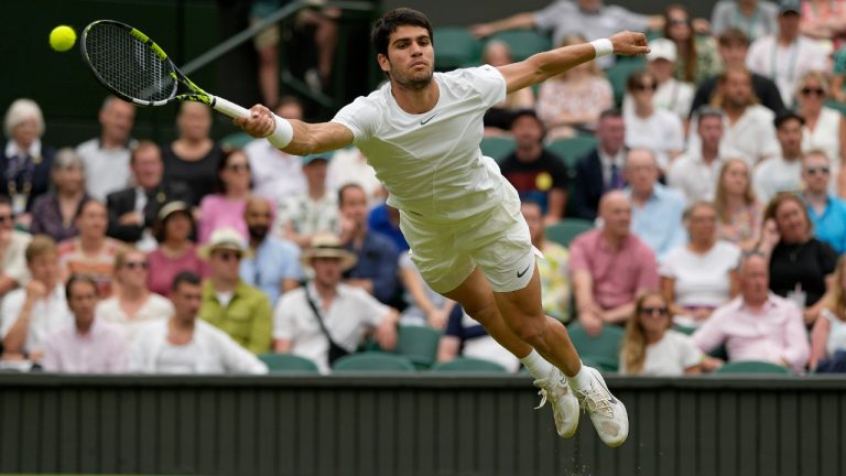 Spain's Carlos Alcaraz returns to Chile's Nicolas Jarry in a men's singles match on day six of the Wimbledon tennis championships in London, Saturday, July 8, 2023. (Alastair Grant/AP)