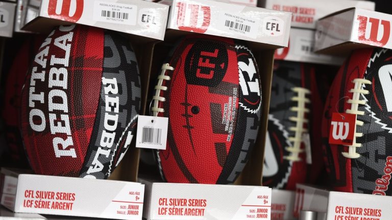 The logos of the CFL and the Ottawa Redblacks are seen on mini footballs for sale at a kiosk at TD Place, home of the Ottawa Redblacks, in Ottawa on Tuesday, May 17, 2022.The Redblacks have acquired the rights to Canadian linebacker Kevin Francis from the Edmonton Elks for a fourth-round pick in the 2024 CFL draft.THE CANADIAN PRESS/Justin Tang 
Justin Tang