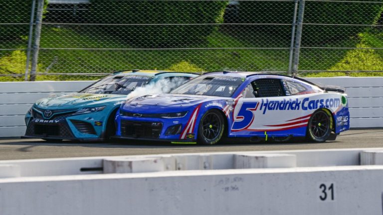 Kyle Larson (5) rubs fenders with Denny Hamlin (11) under caution during a NASCAR Cup Series auto race at Pocono Raceway, Sunday, July 23, 2023, in Long Pond, Pa. (Derik Hamilton/AP)