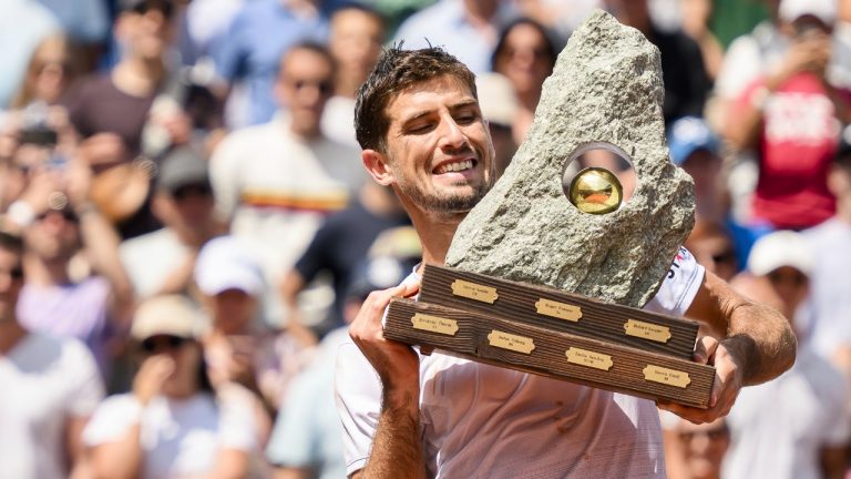 The winner Pedro Cachin of Argentina holds the trophy after the victory against Albert Ramos-Vinolas of Spain during their final match at the Swiss Open tennis tournament in Gstaad, Switzerland, Sunday, July 23, 2023. (Jean-Christophe Bott/Keystone via AP)