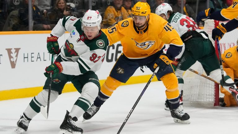 Minnesota Wild's Kirill Kaprizov (97) moves the puck against Nashville Predators' Alexandre Carrier (45) in the first period of an NHL hockey game Tuesday, Nov. 15, 2022, in Nashville, Tenn. (Mark Humphrey/AP)