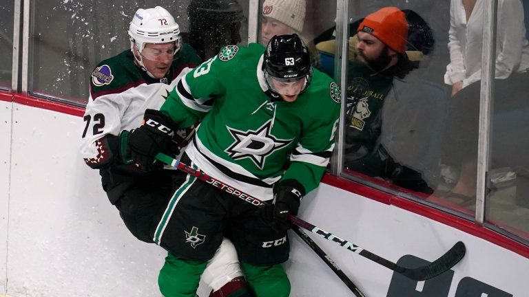 Dallas Stars defenseman Ben Gleason (63) checks Arizona Coyotes centre Travis Boyd (72) during the second period of an NHL preseason hockey game Tuesday, Sept. 27, 2022, in Tulsa, Okla. (Sue Ogrocki/AP)