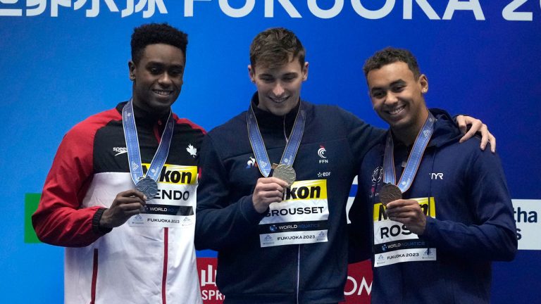 Medalists, from left to right, Josh Liendo of Canada, silver, Maxime Grousset of France, gold, and Dare Rose of the U.S., bronze celebrate during the medal ceremony for the men's 100m butterfly at the World Swimming Championships in Fukuoka, Japan. Lee Jin-man/AP)