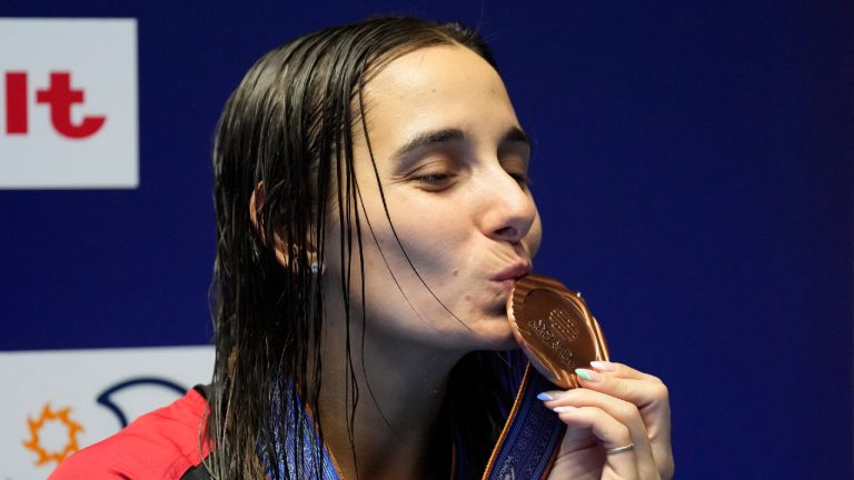 Pamela Ware of Canada kisses her bronze medal after the women's 3m springboard diving final at the World Swimming Championships in Fukuoka, Japan, Friday, July 21, 2023. (Lee Jin-man/AP)