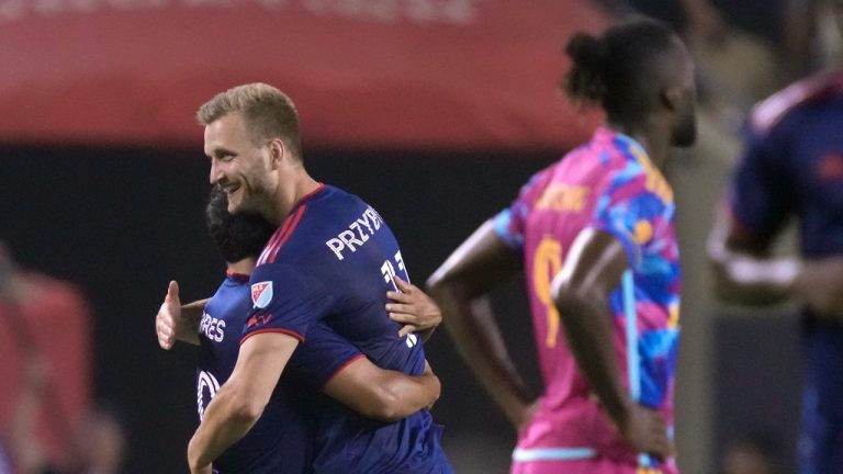 Chicago Fire midfielder Jairo Torres, left, hugs Kacper Przybyłko after Przybyłko's goal in the second half of an MLS soccer match against the Toronto FC, Saturday, July 15, 2023, in Chicago. The Fire won 1-0. (Charles Rex Arbogast/AP)