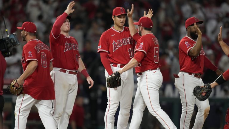 Los Angeles Angels designated hitter Shohei Ohtani (17), relief pitcher Dominic Leone (52) and other players celebrate a 7-5 win over the San Francisco Giants in a baseball game in Anaheim, Calif., Tuesday, Aug. 8, 2023. (Ashley Landis/AP)