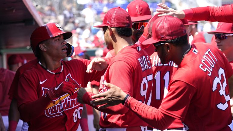 St. Louis Cardinals' Masyn Winn is congratulated in the dugout after scoring on a double hit by Alec Burleson during the first inning of a spring training baseball game against the Washington Nationals, Sunday, March 12, 2023, in Jupiter, Fla. (Lynne Sladky/AP)