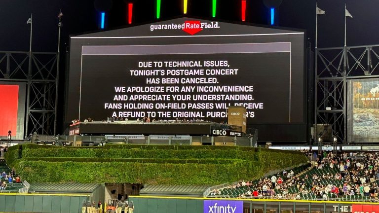 A message on the main scoreboard at Guaranteed Rate Field announces the cancellation of an 90s concert that was to feature Vanilla Ice, Tone Loc, and Rob Base after a baseball game between the Chicago White Sox and the Oakland Athletics, Friday, Aug. 25, 2023, in Chicago. (Charles Rex Arbogast/AP Photo)
