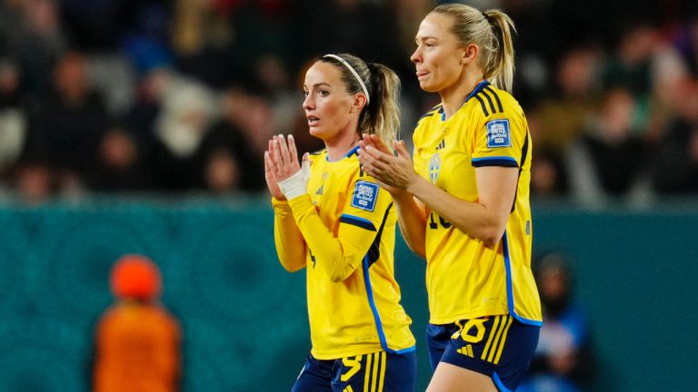 Sweden's Kosovare Asllani, left, and Fridolina Rolfo applaud as they leave the pitch to be substituted during the Women's World Cup quarterfinal soccer match between Japan and Sweden at Eden Park in Auckland, New Zealand, Friday, Aug. 11, 2023. (Abbie Parr/AP)