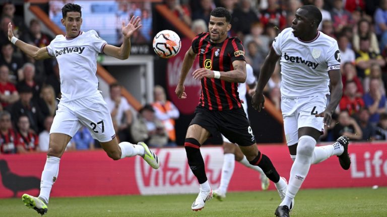 Bournemouth's Dominic Solanke battles for the ball with West Ham United's Nayef Aguerd, left, and Kurt Zouma during the English Premier League soccer match between Bournemouth and West Ham United at the Vitality Stadium, Bournemouth, England, Saturday Aug. 12, 2023. (Simon Galloway/PA via AP)