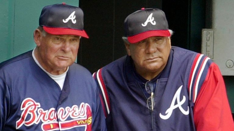 FILE - Atlanta Braves manager Bobby Cox, left, and coach Pat Corrales, right, watch the action during a baseball spring training win over the Tampa Bay Devil Rays, March 2, 2002, in St. Petersburg, Fla. Corrales, who managed Texas, Cleveland and Philadelphia before a long stint on the Braves coaching staff under Hall of Fame skipper Cox, has died at age of 82. (Mark Duncan/AP)