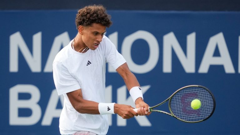 Canada's Gabriel Diallo returns a shot Great Britain's Daniel Evans during tennis action of the National Bank Open in Toronto, Tuesday, Aug. 8, 2023. (Mark Blinch/THE CANADIAN PRESS)